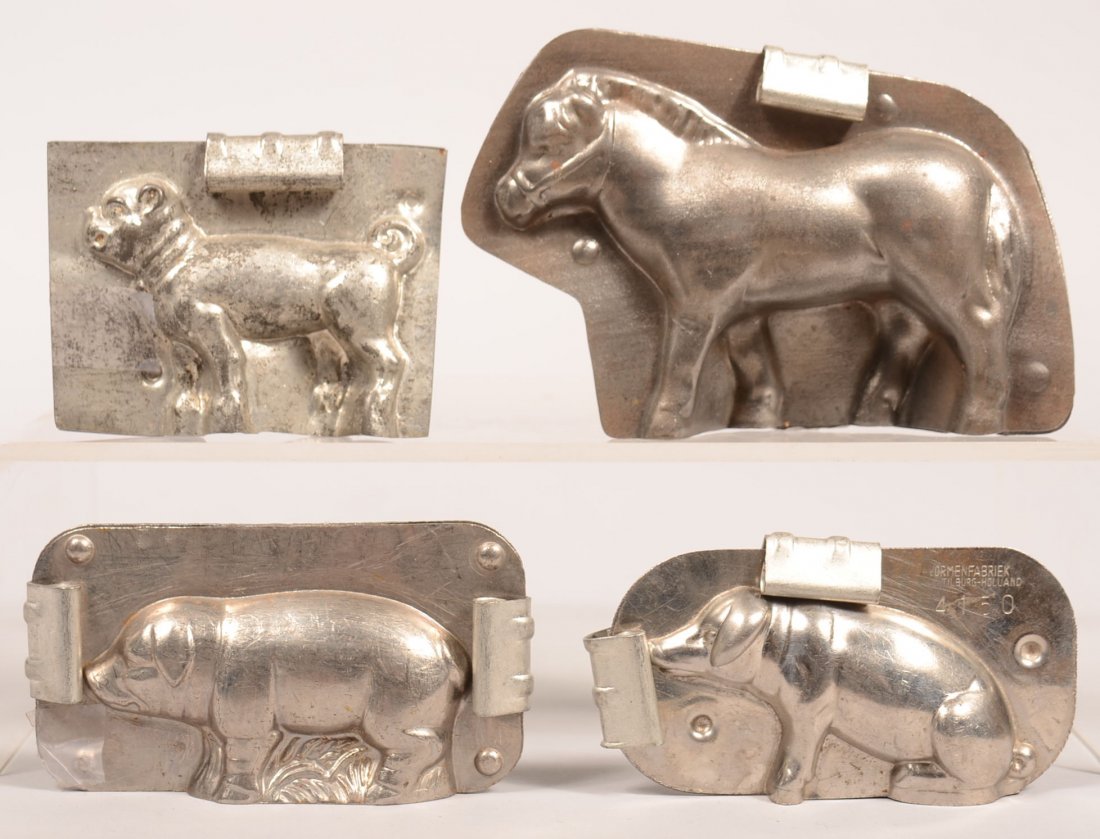 319. Four Animal Chocolate Molds. Pony, Dog, Seated Pig: 319. Four Animal Chocolate Molds. Pony, Dog, Seated Pig signed Vormenfabrick Tilburg-Holland and Standing Pig signed Schwarzer,2-1/2"h.- 3-3/4"h. Condition: Good.