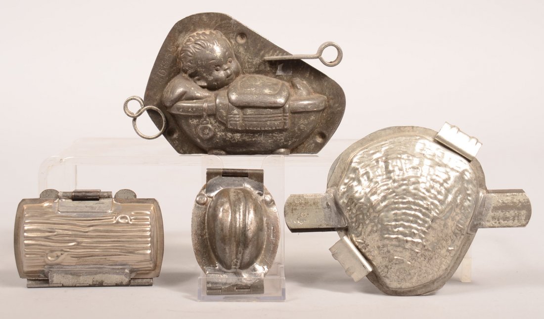 332. Grouping of Four Chocolate Molds, Child in: 332. Grouping of Four Chocolate Molds, Child in Bathtub marked by Reiche, #26355, 3-1/2"h. Shell 5-3/4"l., log3-1/2"l. and a Hat 3"l. Condition: Good.