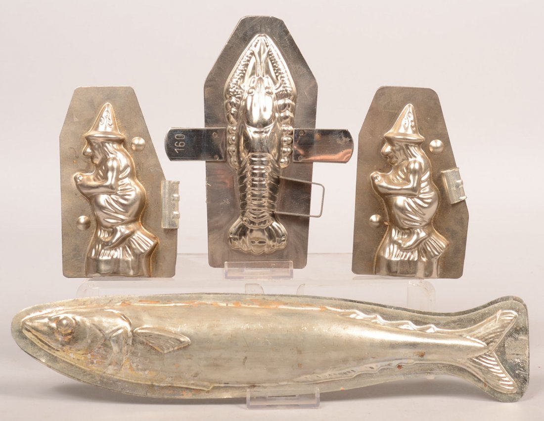 336. Grouping of Four Chocolate Molds. Two Halloween: 336. Grouping of Four Chocolate Molds. Two Halloween Witches, Lobster and a fish, witches 5-1/2"h. fish 14"l. and lobster 7-1/2"l. Condition: Good.