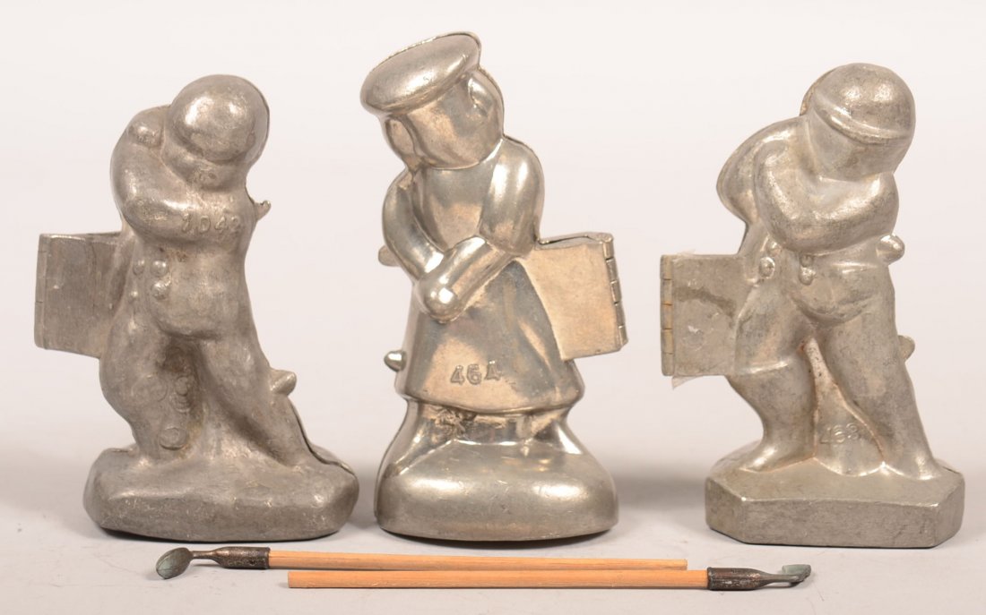351. Three Golfer Pewter Ice Cream Molds. Two Males #: 351. Three Golfer Pewter Ice Cream Molds. Two Males # 1042 and 463, one marked E. & Co. NY, Female #464, 5"h. Condition: Good.