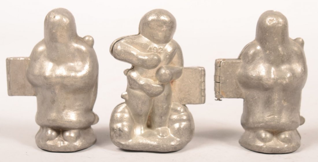 352. Three Figural Pewter Ice Cream Molds. Two Santa #: 352. Three Figural Pewter Ice Cream Molds. Two Santa # 991 and marked E. & Co. NY, Cherub #492, 4-1/2"h. Condition: Good.