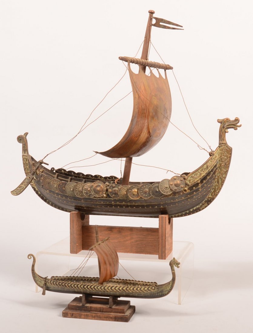378. Two Brass Viking Ship Models with Serpent head: 378. Two Brass Viking Ship Models with Serpent head Bows. Both having single sails, larger having an etched Thunderbird sail. 10-1/2" and 16-1/2' long. Condition: Good with minor losses.