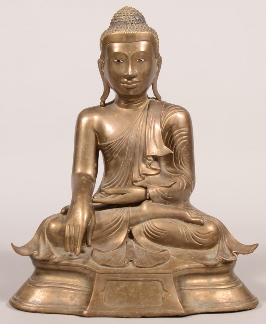 395. Brass Seated Hindu God Statue. Hollow cast figure: 395. Brass Seated Hindu God Statue. Hollow cast figure with enamel eyes, base weighted with red clay earthenware. 18-1/2"h. Condition: Good.