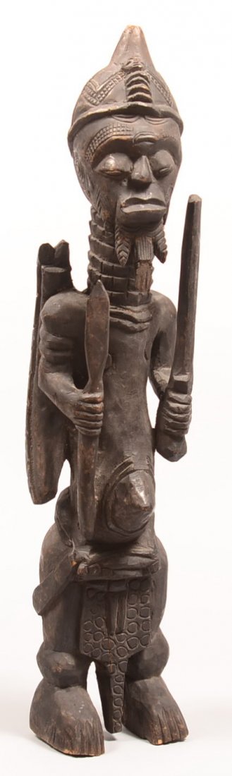 405. African Carved Wood Warrior Figure holding a spear: 405. African Carved Wood Warrior Figure holding a spear and a club, 25-1/2" high. Condition: Good with some cracks and wear.