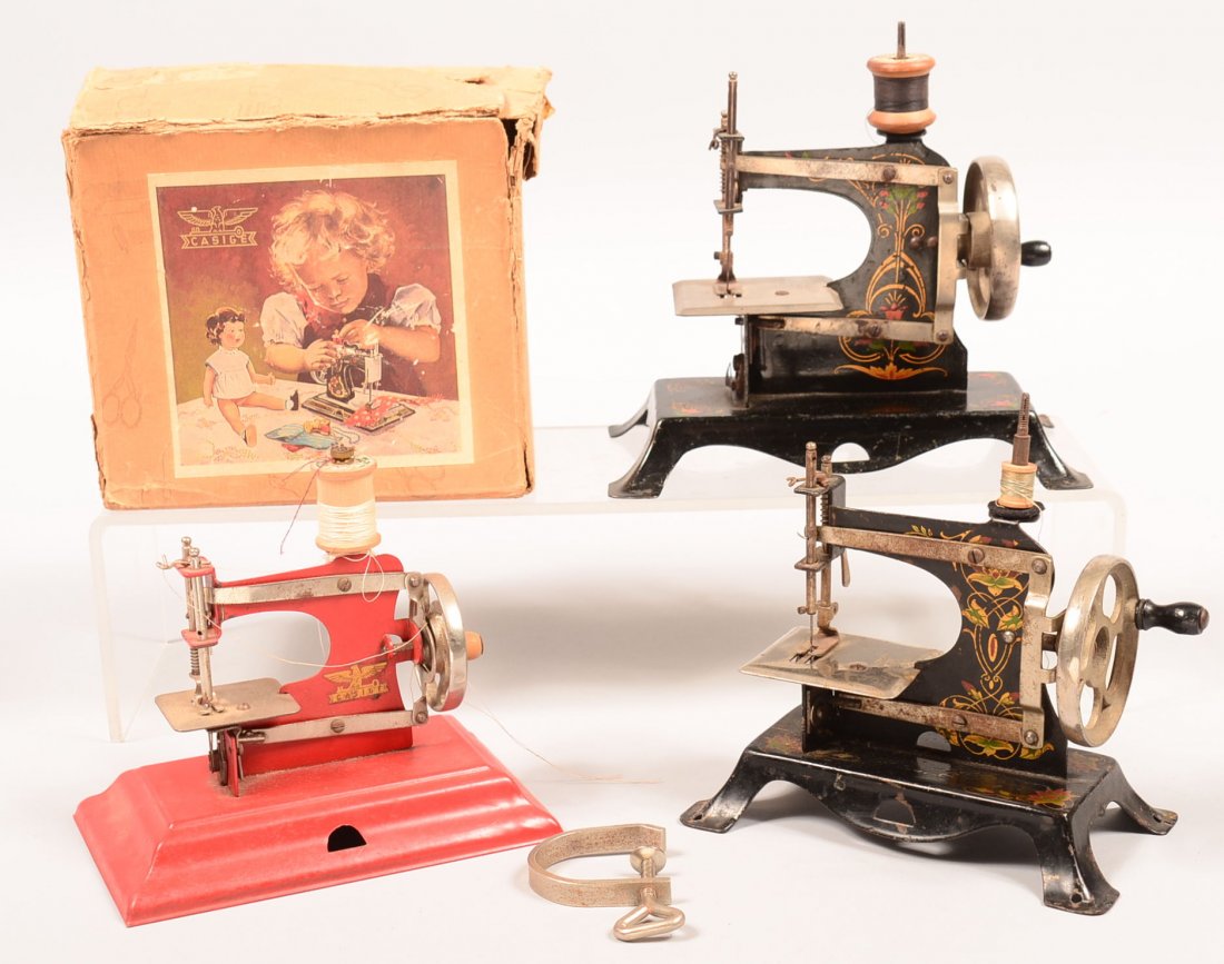 538. Three Various Casige (Germany) Vintage Children's: 538. Three Various Casige (Germany) Vintage Children's Sewing Machines. (one with tattered box), 6"h to 7-1/2" high. Condition: Good with wear.
