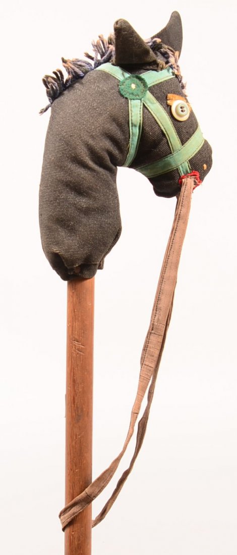 570. Pennsylvania Amish Made Stick Horse, Circa. 1910.: 570. Pennsylvania Amish Made Stick Horse, Circa. 1910. Stuffed fabric head with yarn mane and button eyes. 36" long. Condition: Very good with use wear.