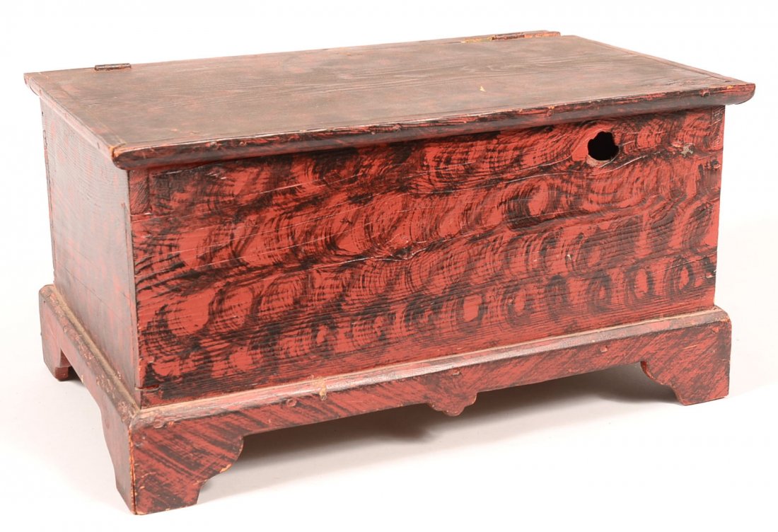 594. 19th Century Pine Miniature Blanket Chest with: 594. 19th Century Pine Miniature Blanket Chest with later red and black painted swirl decoration. 11"h x 21-1/4"w x 13-1/4"d. Condition: Good with minor loss and wear.