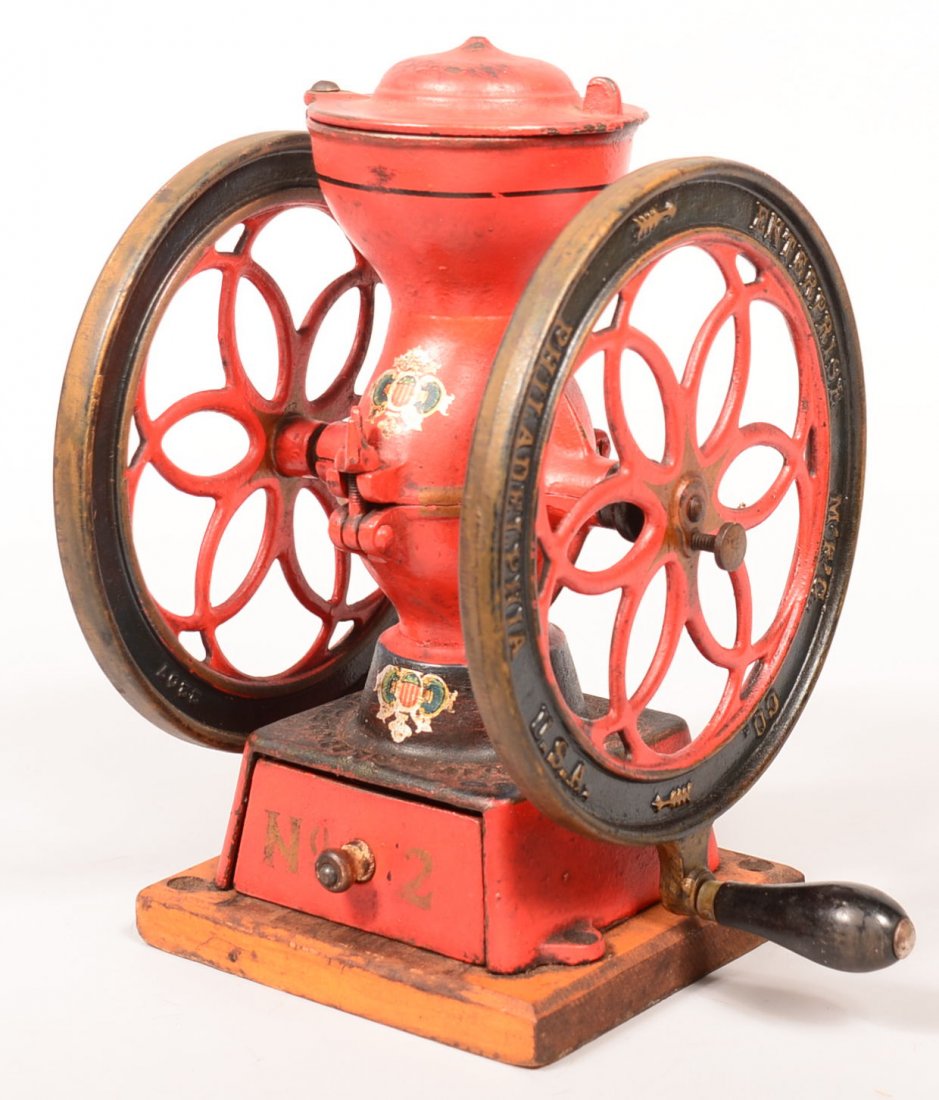 627. Enterprise #2 Cast Iron Coffee Mill. Signed: 627. Enterprise #2 Cast Iron Coffee Mill. Signed Enterprise Mfg. Co. Philadelphia, Counter top model having double wheel with grip handle, Painted red and blue with highlights, applied decals, cast ir