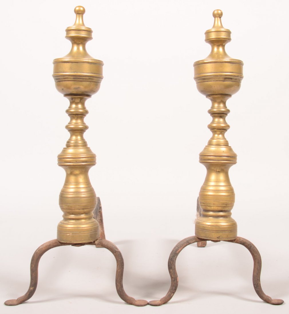 651. Pair of Brass Turned Andirons. Wrought iron legs: 651. Pair of Brass Turned Andirons. Wrought iron legs with hammered penny feet, 17"h. Condition: Good.
