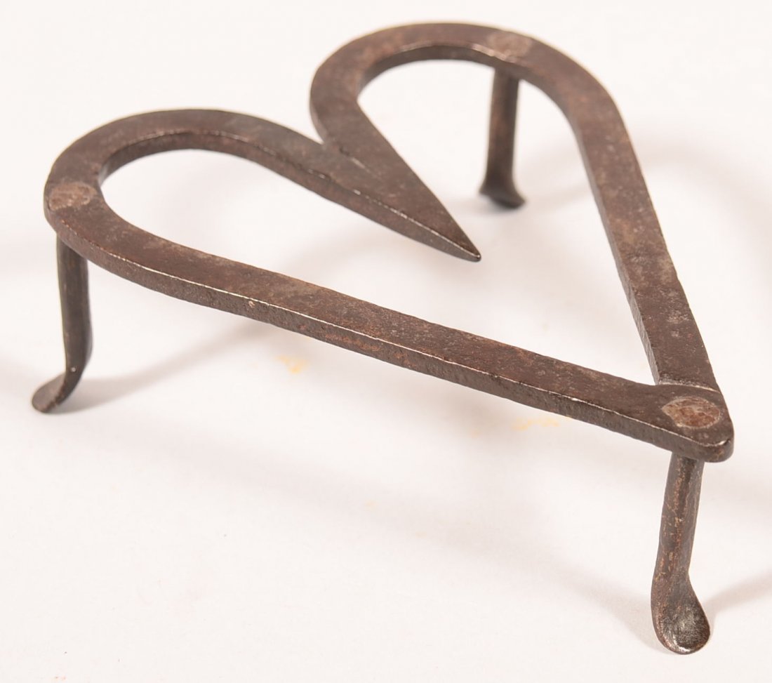 656. Wrought Iron Heart Shape Trivet. Three legs with: 656. Wrought Iron Heart Shape Trivet. Three legs with pad feet, 1-3/4"h. x 6"l.x 4-3/4", Conditon: Good.