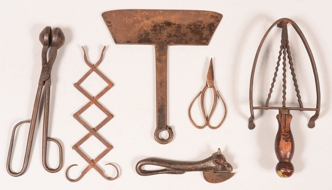 670. Six Pieces of Iron Hearth and Kitchenware. Two: 670. Six Pieces of Iron Hearth and Kitchenware. Two Coal Tongs, One with accordion action, Food Chopper, Cow Head Can Opener, Trivet with wooden handle and small pair of Scissors, 4-1/2"l.-11-1/2"l. C