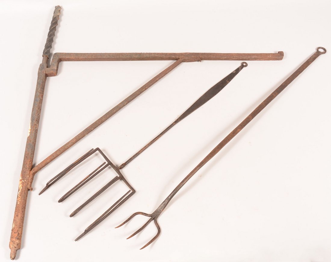 675. Three Hand Forged Iron Hearth Equipment. Fireplace: 675. Three Hand Forged Iron Hearth Equipment. Fireplace Crane, 37"h. x 33-1/4"l. Large three-tine flesh fork, 39-1/2"l., Toaster with extended feet and hinged swing handle, 32-1/2"l. Condition: Good a