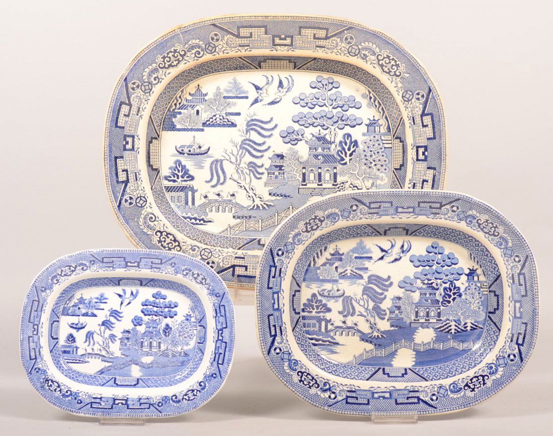 792. Three Blue Willow Pattern Ironstone China Platters: 792. Three Blue Willow Pattern Ironstone China Platters by various makers. 9-1/4", 12-1/4" and 16-1/4". Condition: Good with minor stains.
