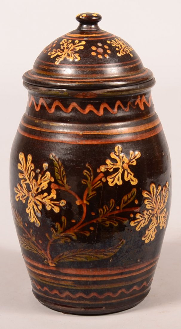 Greg Shooner 2004 Redware Covered Jar. Polychrome slip: Greg Shooner 2004 Redware Covered Jar. Polychrome slip floral decorated on chocolate color background, 9-1/2"h. Condition: Good.