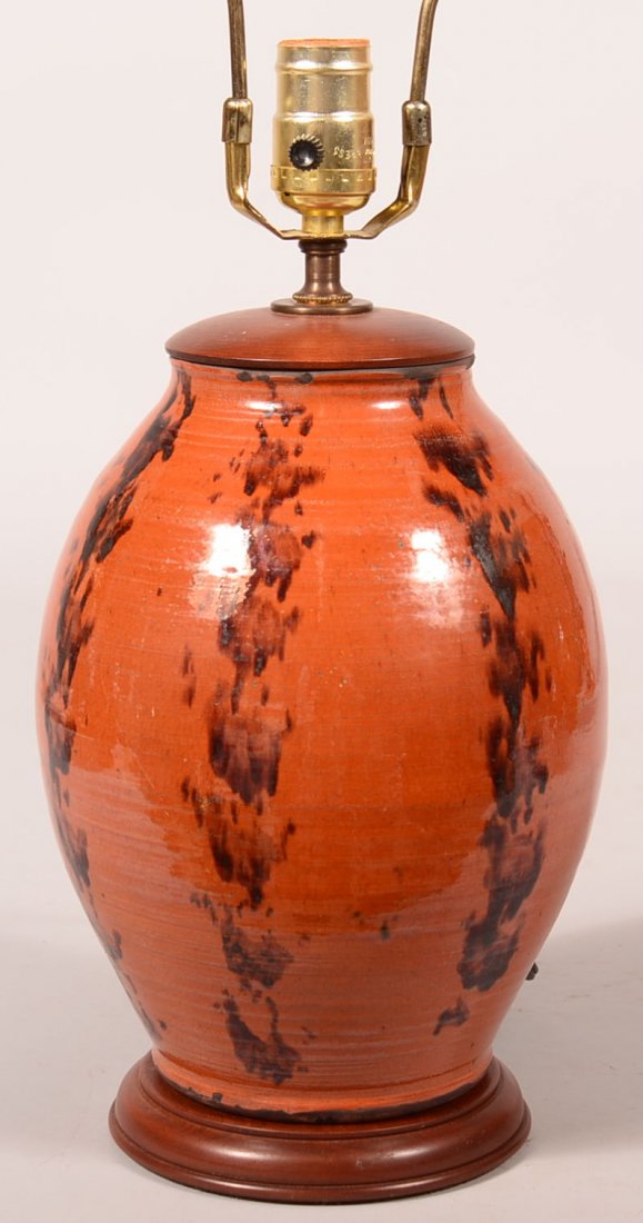 Greg Shooner Redware Table Lamp. Bulbous form with: Greg Shooner Redware Table Lamp. Bulbous form with manganese stripe decorations, 15"h. measure to the top of light socket, Condition: Very good.