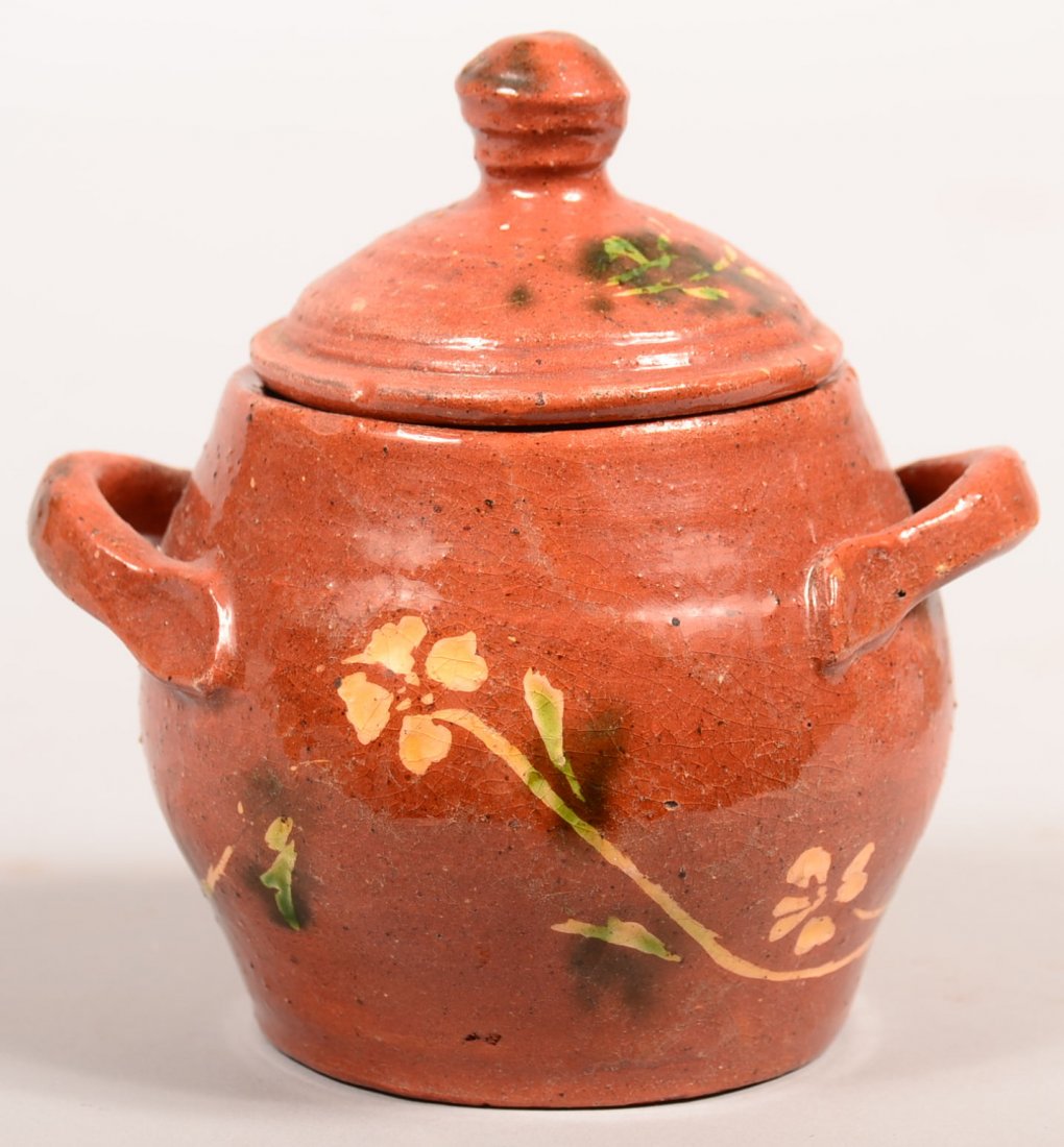 Gleaves Redware Covered Sugar Bowl. Bulbous form with: Gleaves Redware Covered Sugar Bowl. Bulbous form with floral decorations, applied handles, 5"h. Condition: Good.
