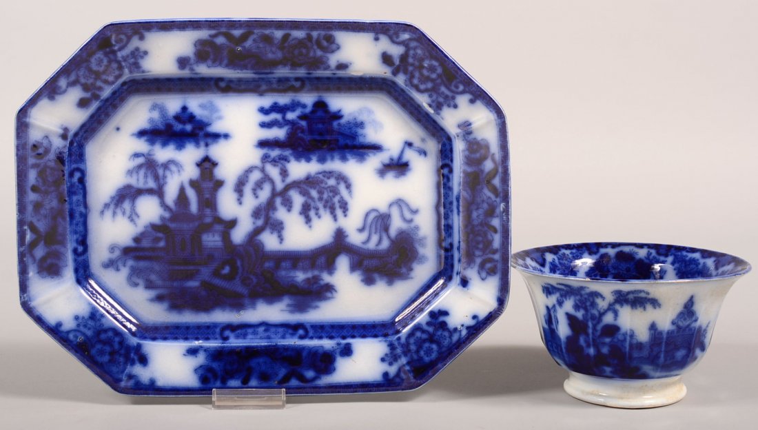 Two Pieces of Flow Blue Transfer Decorated Ironstone: Two Pieces of Flow Blue Transfer Decorated Ironstone China. "Pelew" pattern 13-1/2" platter by E. Challinor and "Scinde" pattern waste bowl, 3-3/4" h. Condition: Platter is good, bowl has a pin nip on