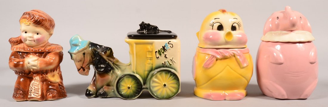 Four Various Figural Ceramic Cookie Jars. Shawnee: Four Various Figural Ceramic Cookie Jars. Shawnee Pottery Pink Elephant cookie jar, 11"h., Brush McCoy Davy Crockett Cookie Jar, 10-1/2"h., American Bisque Donkey and Cart cookie jar, 9"h., and Chick