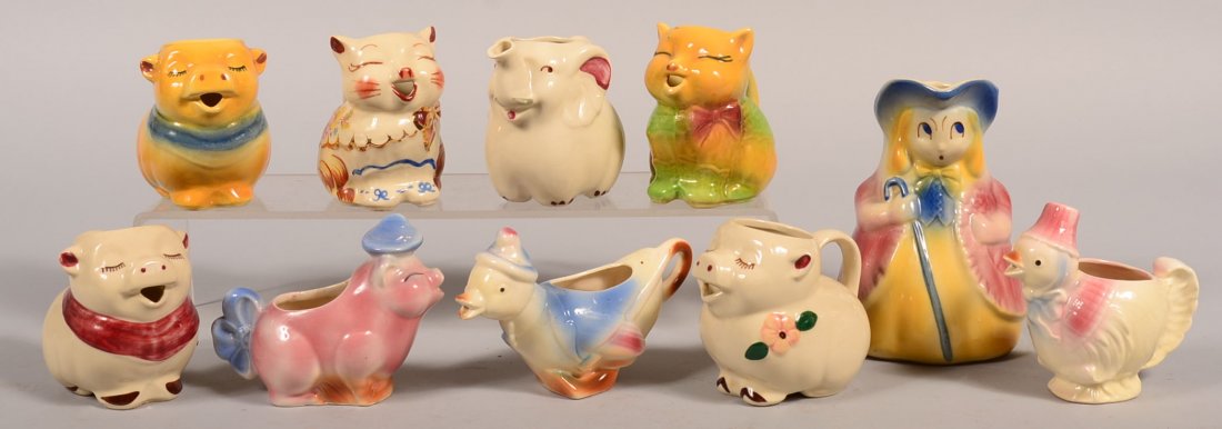 Ten Various Shawnee Pottery Pitchers. Bo Peep pitcher,: Ten Various Shawnee Pottery Pitchers. Bo Peep pitcher, Smiley Pig creamer, Elephant creamer, Puss-N-Boots creamer and more. 4-1/2 to 7-1/2" high. Condition: Very good.