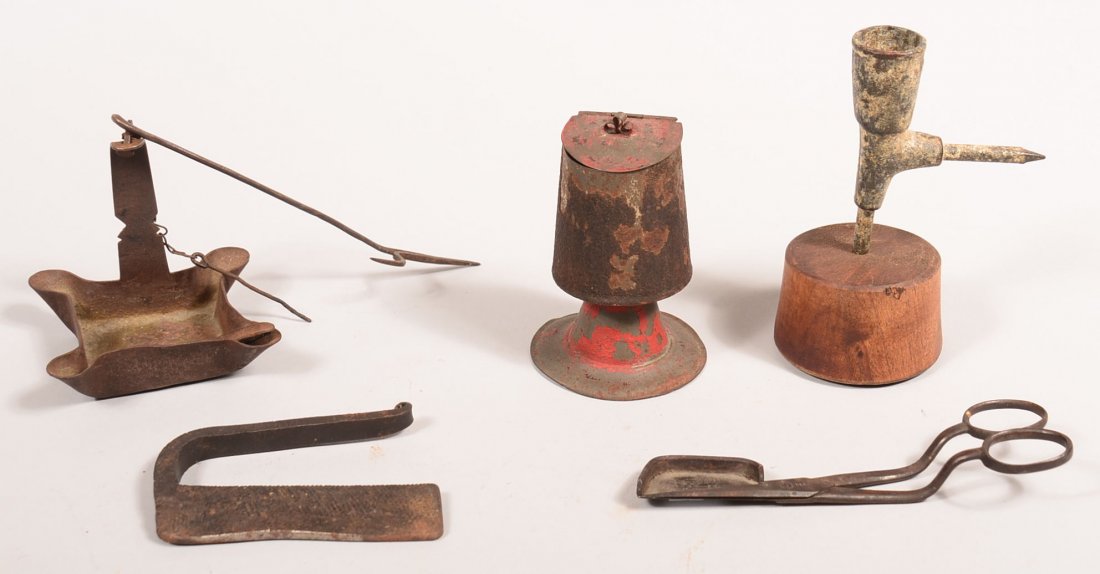 Five pieces of Lighting Devices. Iron Grease lamp, iron: Five pieces of Lighting Devices. Iron Grease lamp, iron sticking tommy lamp on wooden base, tin match holder with paint worn off, iron striker and scissor type candle trimmer, 2-3/4"h. to 5"h. Conditi