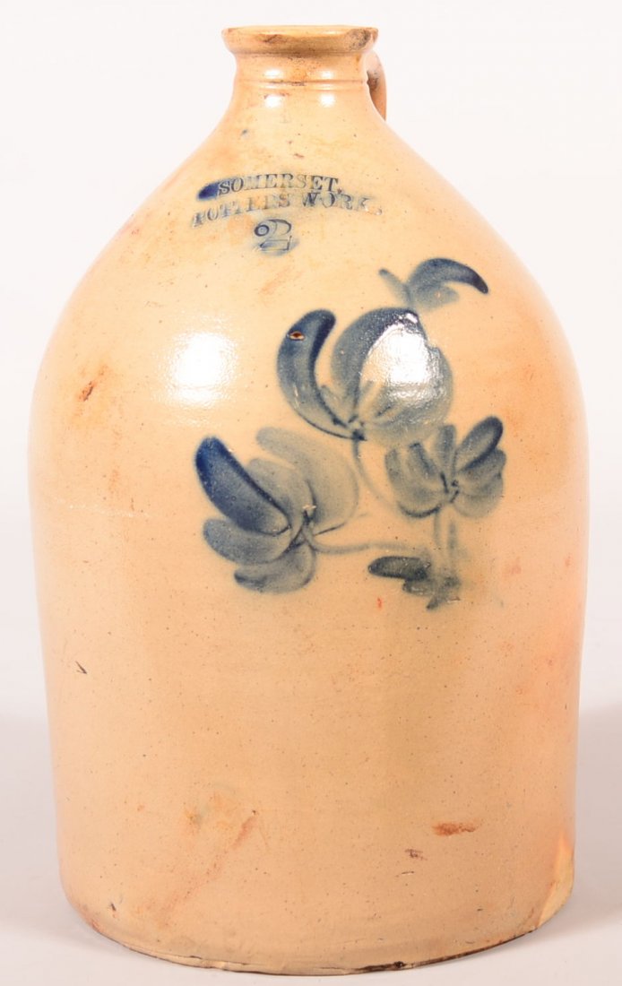 Somerset Potters Works Tulip Decorated Two Gallon: Somerset Potters Works Tulip Decorated Two Gallon Stoneware Jug. Cobalt blue tulip decorated, flatten rim, 15"h. Condition Good and restoration to rim at handle and backside, base chips.