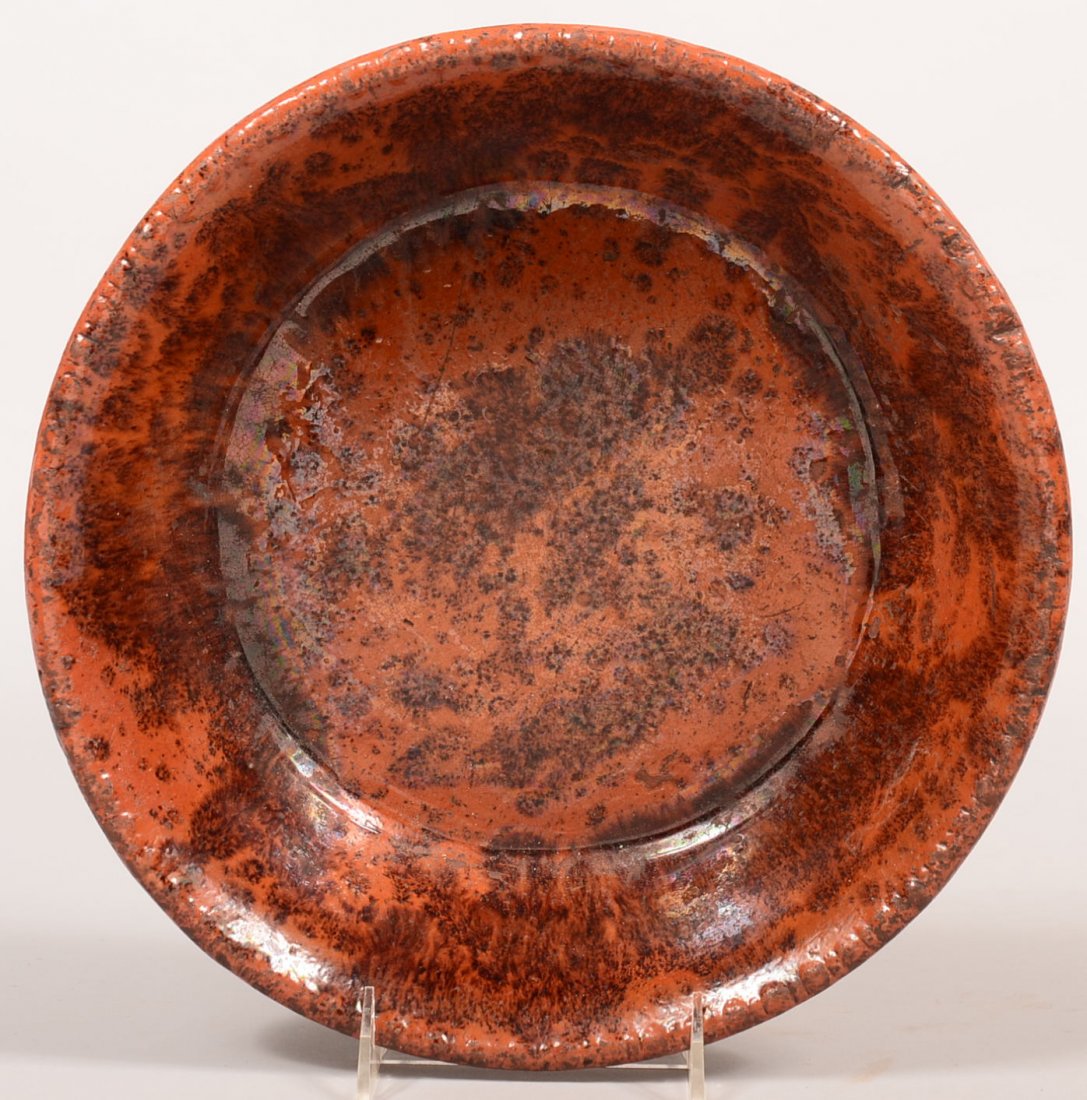 19th Century Glazed Redware Bowl. Round form with: 19th Century Glazed Redware Bowl. Round form with flared sides and manganese splotches decorations, 3"h. x 11-3/4"dia. Condition: Good.