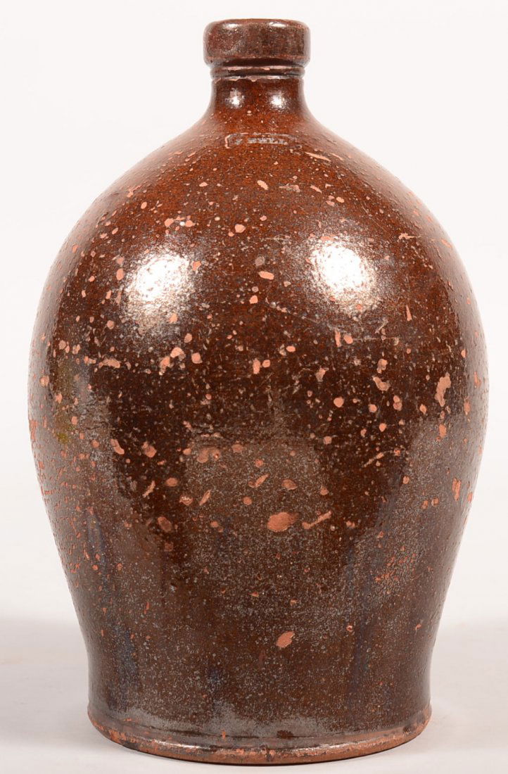 J. Bell Redware Jug. Bulbous form with applied handle,: J. Bell Redware Jug. Bulbous form with applied handle, impressed J. Bell, 12-1/4"h. Condition: Repaired handle and pitting.