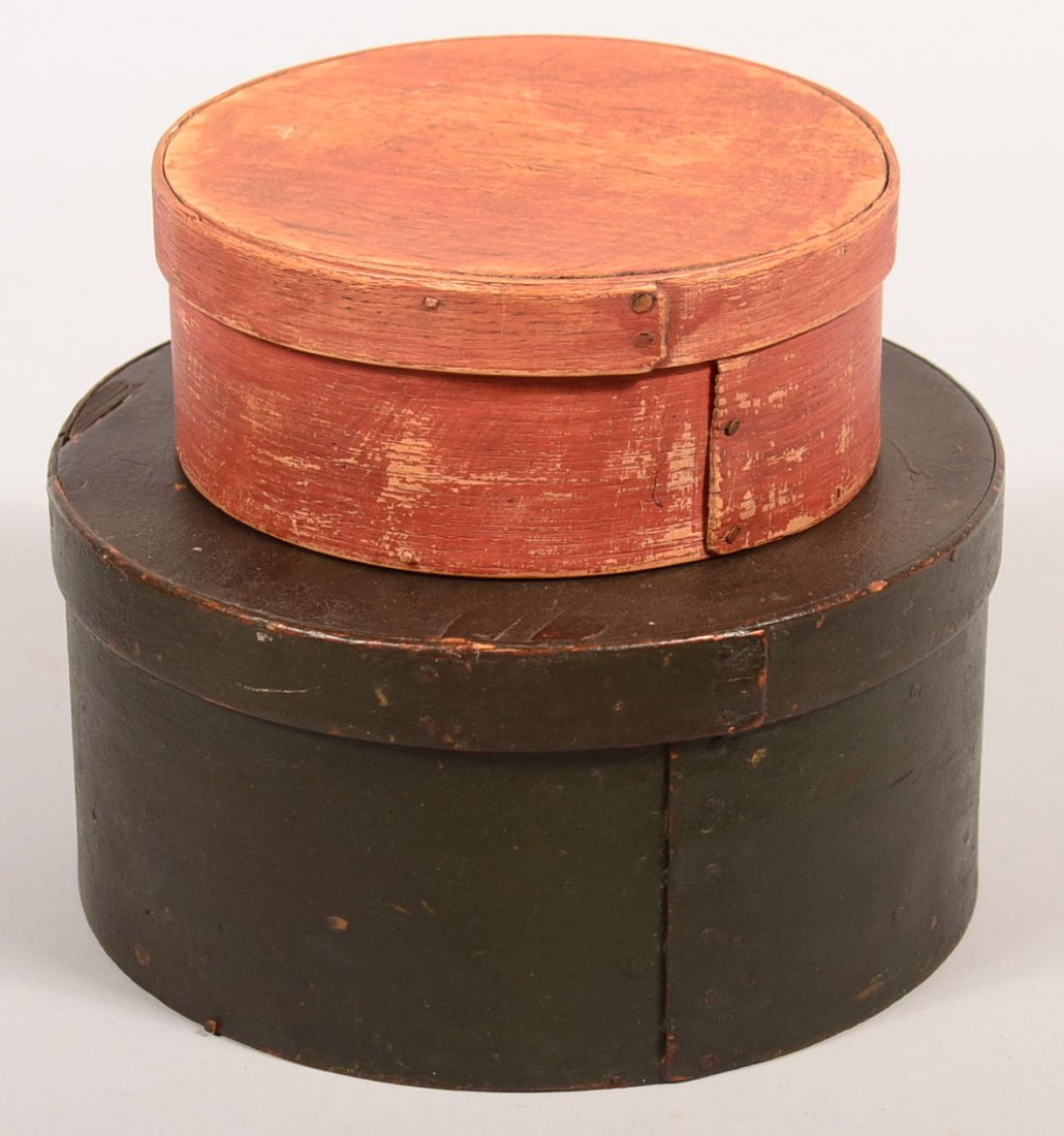 Two Painted Wooden Pantry Boxes. Round form with: Two Painted Wooden Pantry Boxes. Round form with lapped joint with tacks, painted red and green, 2-3/4" and 4-1/2"h. 6-3/4" and 8-3/4"dia.Condition: Good and worn paint.