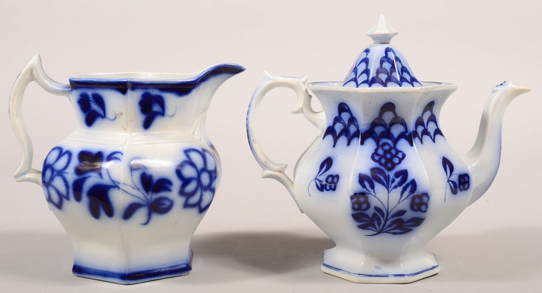 Two Pieces of Flow Blue Brush Stroke Ironstone China.: Two Pieces of Flow Blue Brush Stroke Ironstone China. "Gingham Flower" pattern teapot, 9-1/2"h. and "Daisy Seven Petals" pattern water pitcher, 8"h. Condition: Teapot has a restoration on base, pitche