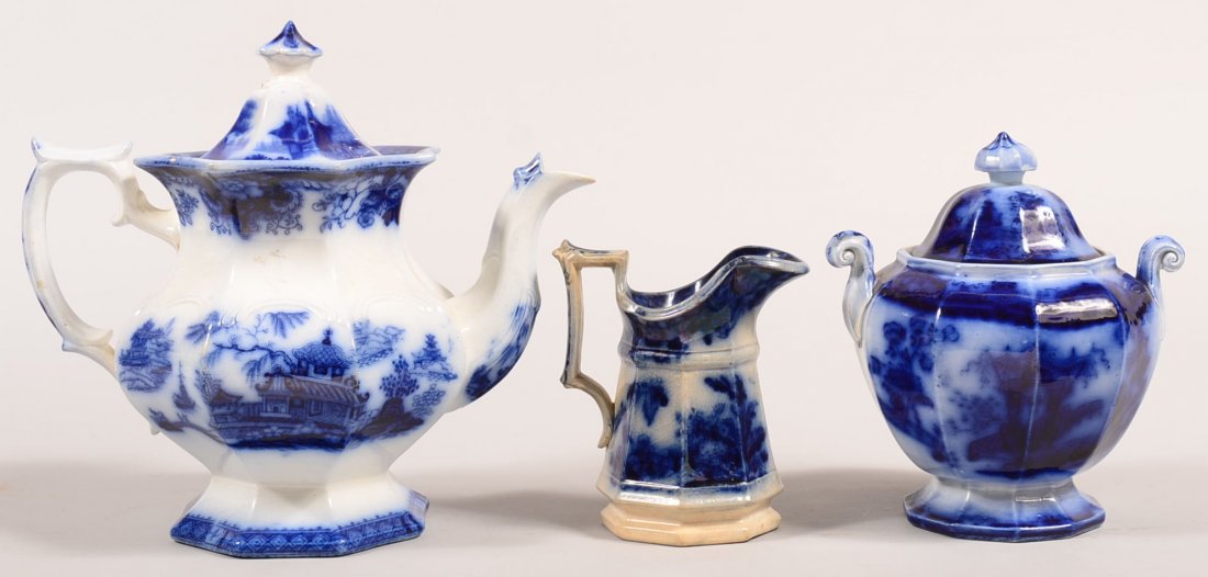 Three Pieces of Flow Blue Transfer Decorated Ironstone: Three Pieces of Flow Blue Transfer Decorated Ironstone China. "Cimerian" teapot, (married lid), 10-3/4"h., "Oregon" covered sugar bowl, 7"h. and unknown pattern cream pitcher, 5-1/4"h. Condition: Teap