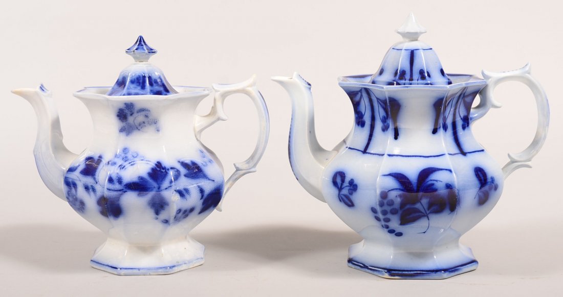 Two Flow Blue Brush Stroke Ironstone China Teapots.: Two Flow Blue Brush Stroke Ironstone China Teapots. "Grapes and Leaves", 9"h. and "Bluebell and Grapes" with Cherry Border, 10"h. Condition: Grapes and Leaves teapot has a spout repair and married lid