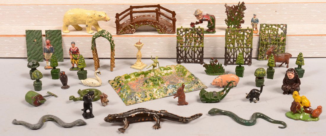 Grouping of Painted Cast Metal Figures. Including: Grouping of Painted Cast Metal Figures. Including Pixieland gardener tending rose, Britain solid cast lizard, Playland Felix the cat walking, trestles, bushes, animals, tallest 2-3/4"h. Condition: Goo