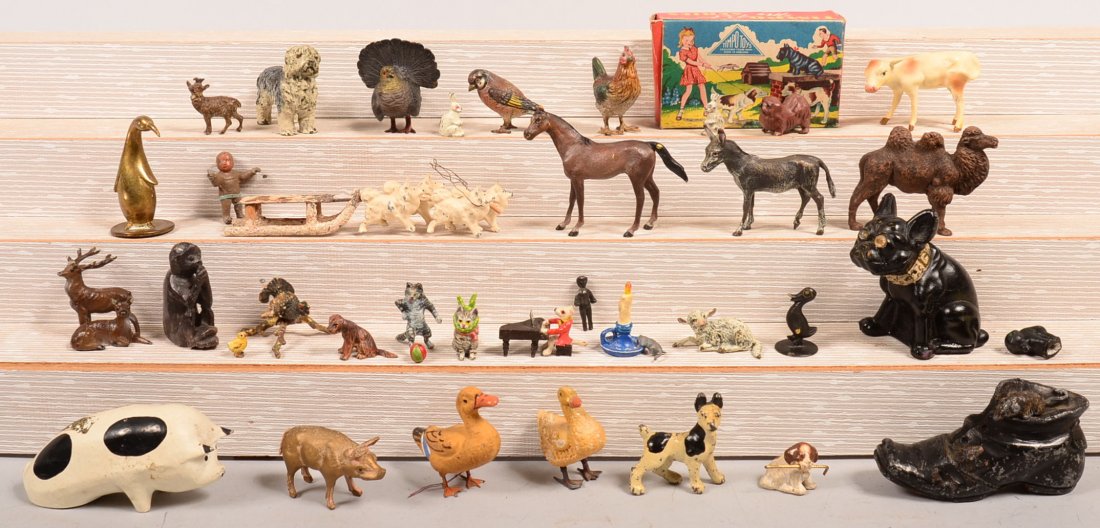 Grouping of Painted Cast metal Animals. Including: Grouping of Painted Cast metal Animals. Including Vienna bronze miniature animals, circa 1950's, German dog team and sled, various other animals, tallest 2-3/4"h. Condition: Good. With use wear.