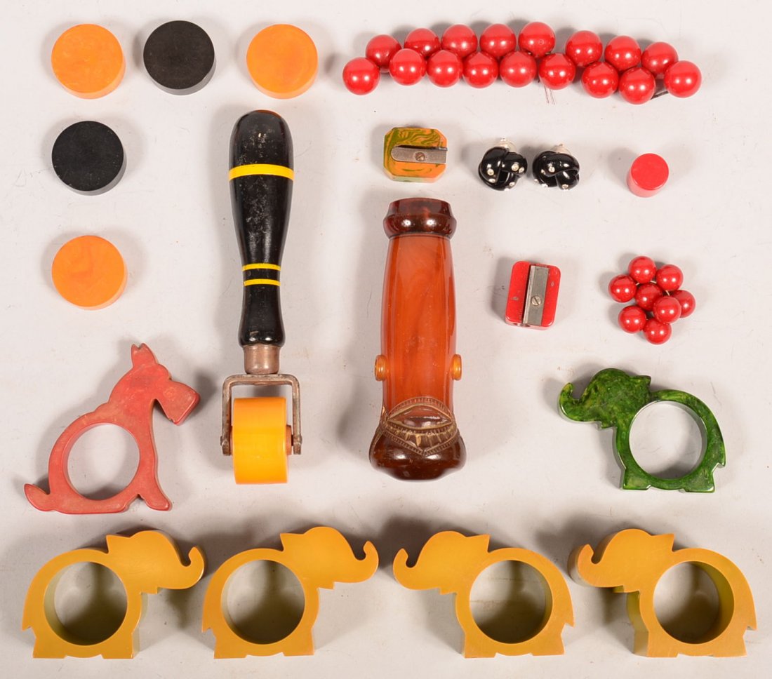 Grouping of Bakelite. Including four matching deep: Grouping of Bakelite. Including four matching deep elephant napkin rings, pencil sharpeners, umbrella handle, checker pieces, 3/8" to 3"h. Condition: Good.
