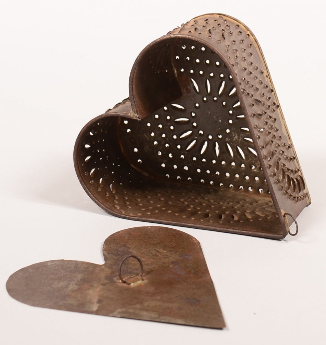 19th Century Punch Tin Heart Shape Cheese Mold with: 19th Century Punch Tin Heart Shape Cheese Mold with tamper, Having geometric design, folded and soldered construction with tubular feet, hanging ring, from the Richard Flanders Smith Coll.3-1/2"h. Con