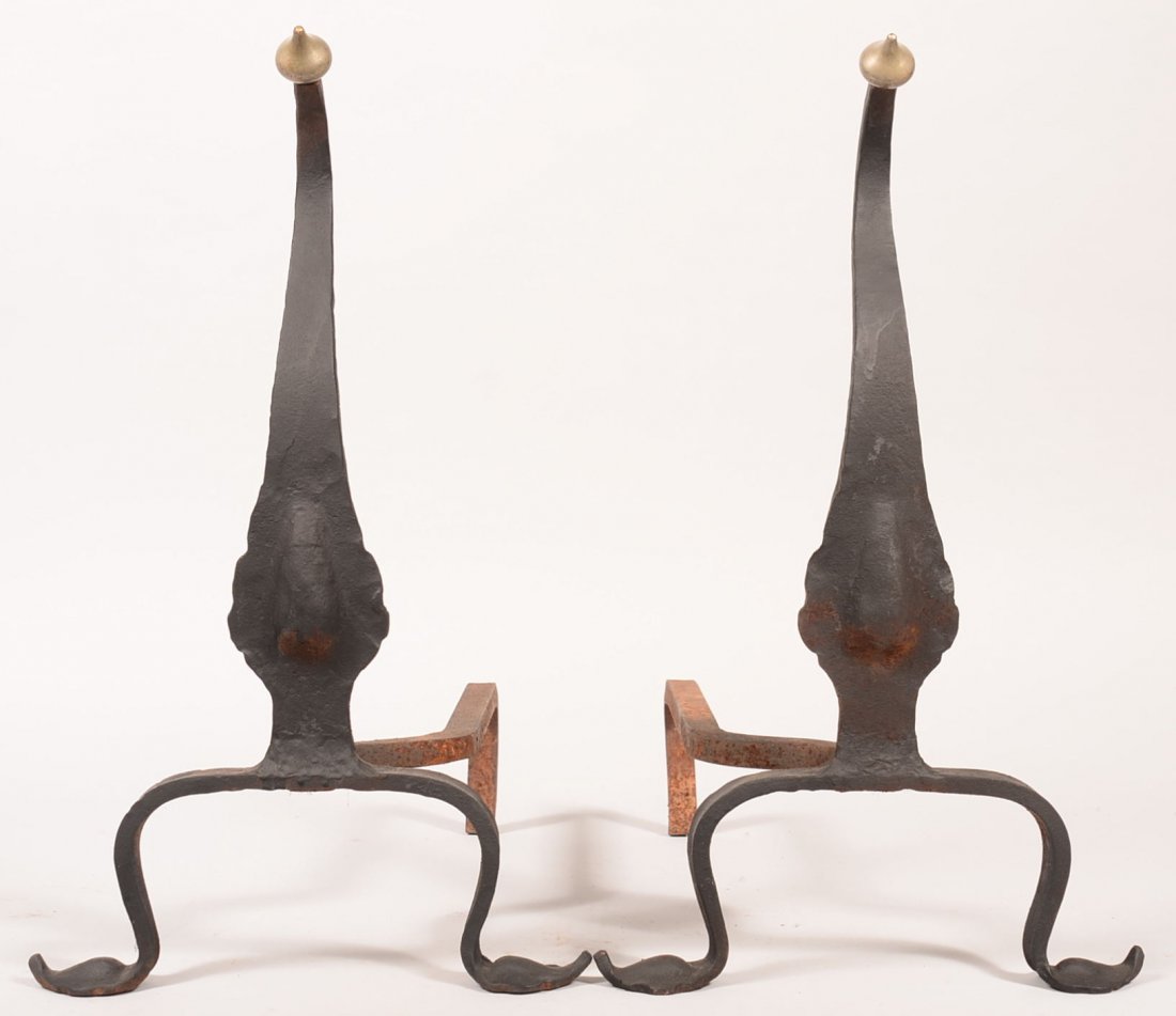 Pair of Wrought Iron Andirons. Curved knife style with: Pair of Wrought Iron Andirons. Curved knife style with Hershey's Style Finial. 19-3/4"h. Condition: Good.
