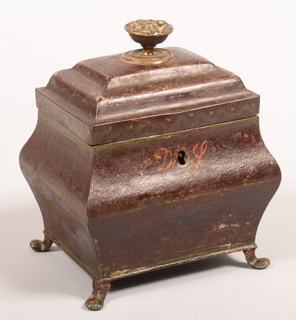 Japanned Tin Tea Caddy with brass finial and paw feet,: Japanned Tin Tea Caddy with brass finial and paw feet, lid with painted swag and dot decorations, painted initial D L on front, divided compartment interior, 6"h. Condition: Good.