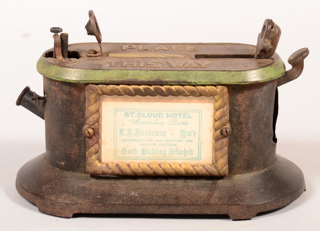 718. Cast Iron Countertop Cigar Cutter and Lighter.: 718. Cast Iron Countertop Cigar Cutter and Lighter. Advertising plaque for St. Cloud Hotel Martinsburg PA. adjusted spring broken , 6-3/4"h. x 10"l. x 5-1/2"d.Condition: Good with denting, adjusted sp