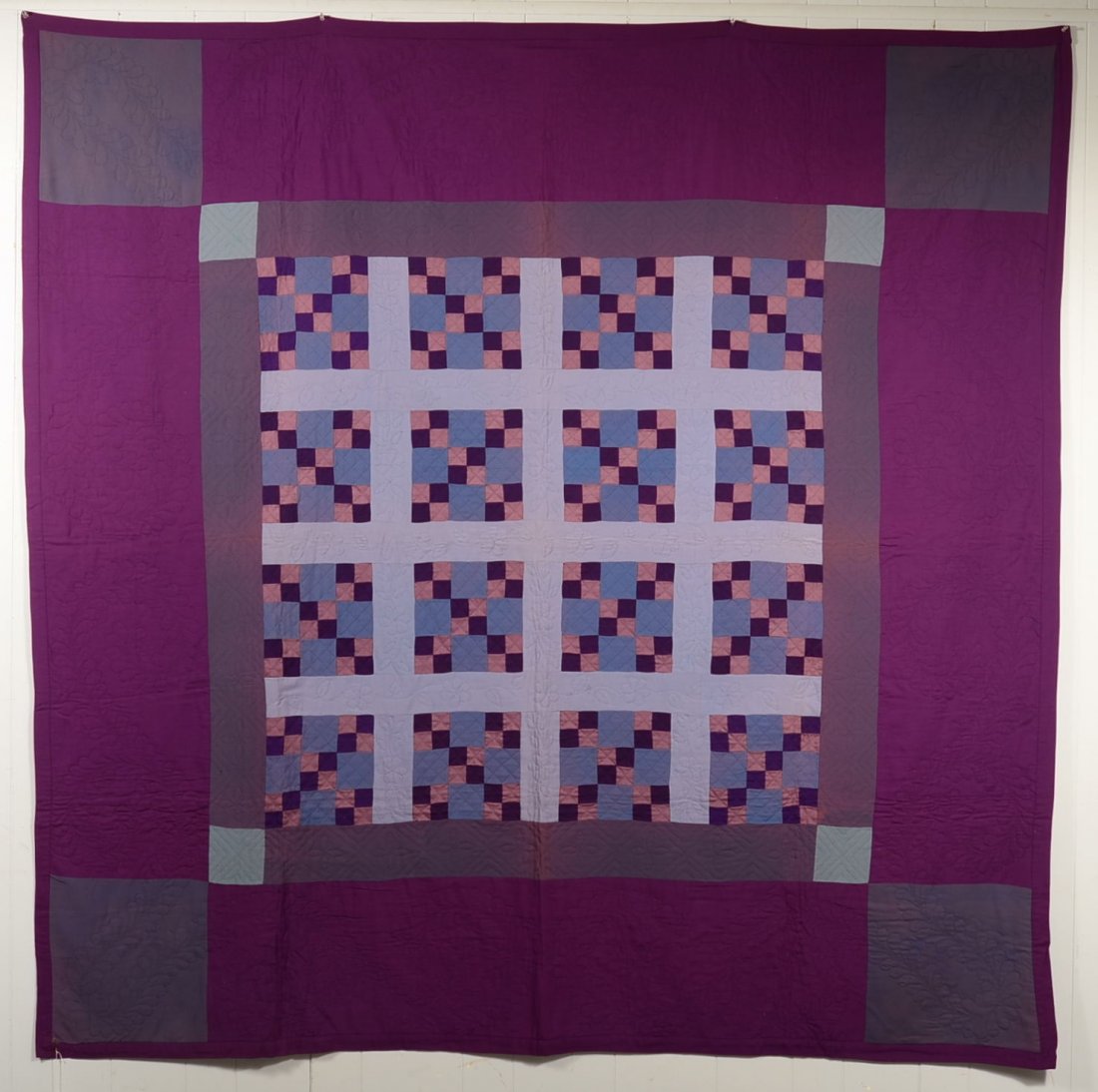 Amish Nine Patch Quilt in blues and maroon, quilted: Amish Nine Patch Quilt in blues and maroon, quilted plume border, 80"x 81"Condition: Good with wear spot on border.