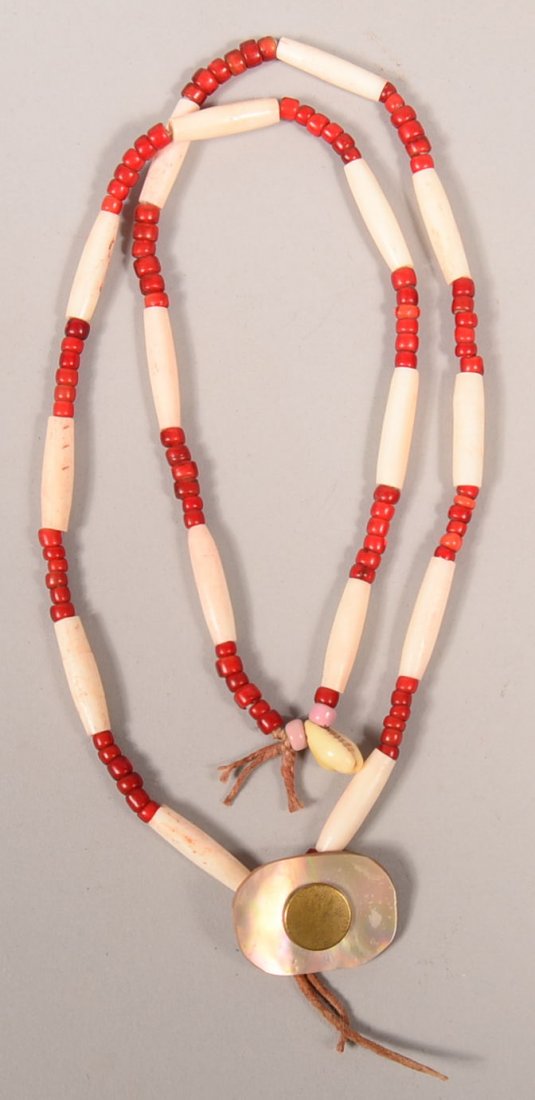 A Plains Indian styled necklace of glass "white heart": A Plains Indian styled necklace of glass "white heart" beads and bone "hair pipe" beads, shell pendant, etc. Very Good