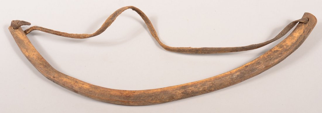 An antique Eskimo walrus rib bow with a walrus hide: An antique Eskimo walrus rib bow with a walrus hide strap used with a drill tipped spindle to work stone, bone, and ivory