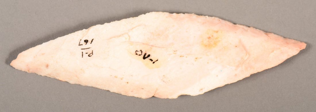 An ancient "harahay knife" of elongated diamond shape: An ancient "harahay knife" of elongated diamond shape fashioned from a pink chert with beveled edge, sharpened - from the S.B. Sisemore collection. (Remnants of glue/fabric adhering)