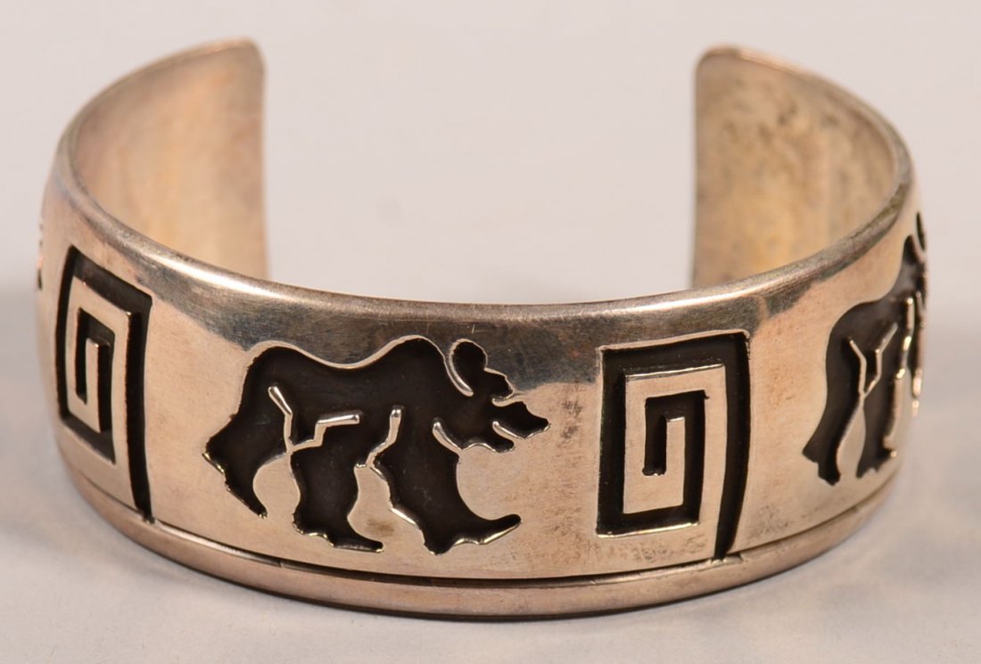 A heavy sterling silver "cuff" type bracelet in Hopi: A heavy sterling silver "cuff" type bracelet in Hopi Indian "overlay" style - 3 walking bears design - signed "Rosco Scott"