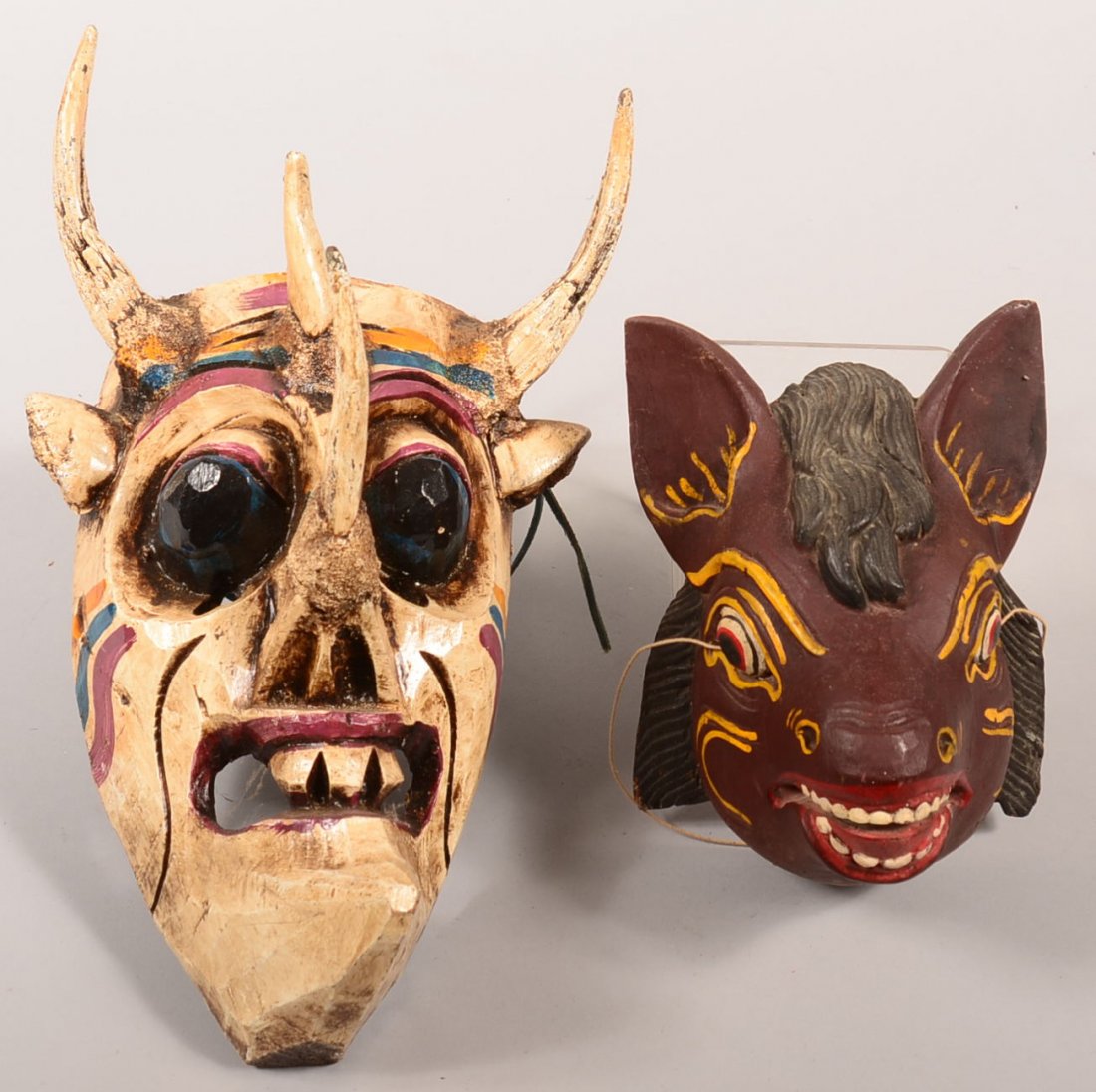 2 Contemporary carved and painted masks - a Balinese: 2 Contemporary carved and painted masks - a Balinese animal mask and a Guatemalan mask with glass eyes and goat horns…scary