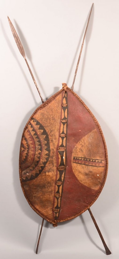 An African warriors rawhide shield and 2 iron tipped: An African warriors rawhide shield and 2 iron tipped spears - Kikuyu type