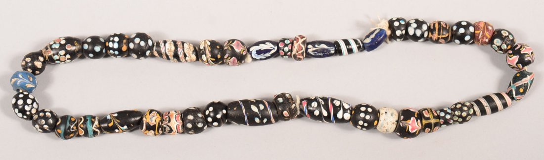A strand of antique Venetian, polychrome glass trade: A strand of antique Venetian, polychrome glass trade beads - this type is often found associated with Crow Indian medicine bundles