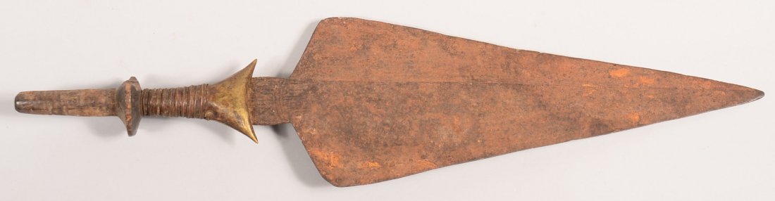 An antique African knife 22" long with a spear head: An antique African knife 22" long with a spear head shape blade and brass and copper mounted handle
