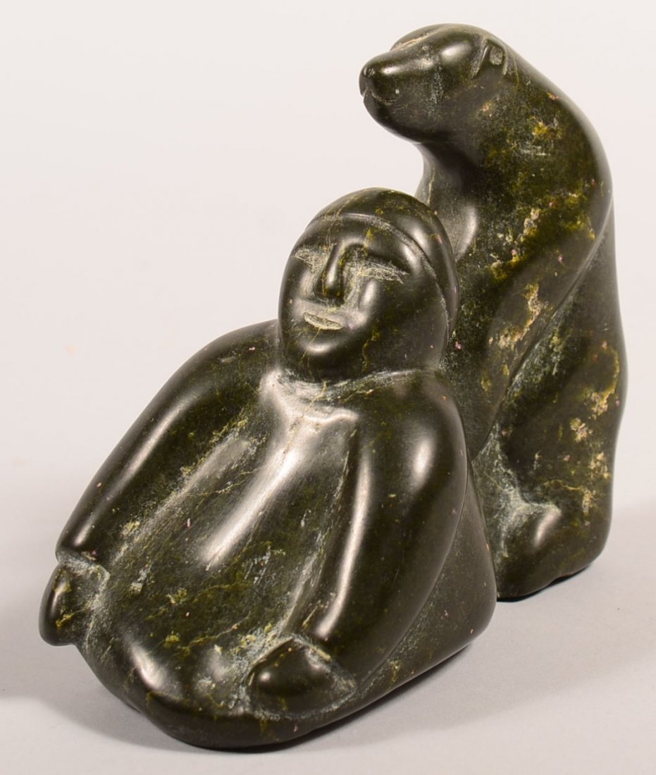 An Inuit stone carving in dark green serpenting "hunter: An Inuit stone carving in dark green serpenting "hunter and bear" - 5 1/4" tall - Good