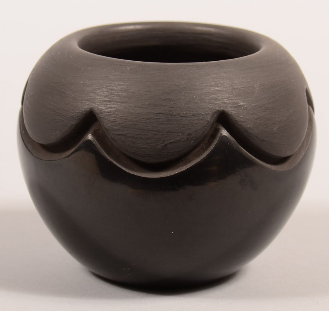 A Santa Clara Pueblo pottery jar, carved and polisehed: A Santa Clara Pueblo pottery jar, carved and polisehed (very minor roughness on side) - 3 1/4" x 4 1/4" - signed, "Tricia Velarde" - Good