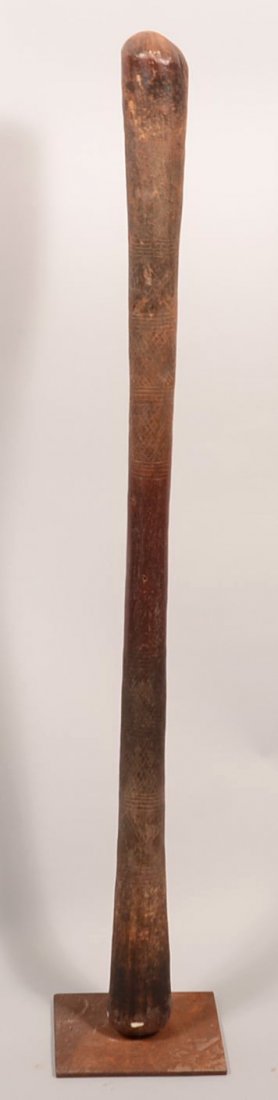 An antique African grain pounding pestle hand carved: An antique African grain pounding pestle hand carved from heavy wood. This object is richly decorated with incise carving and has an old painted surface (comes with iron stand) - Good